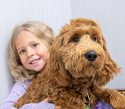 Girl with her dog ready for a visit at Hershey Vet